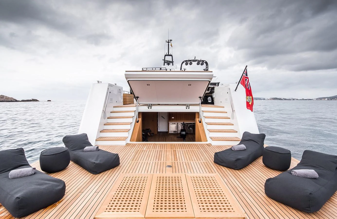 The yacht's aft deck features a spacious lounging area with comfortable seating and a view of the open sea. aboard 27 YXT Yacht for Sale