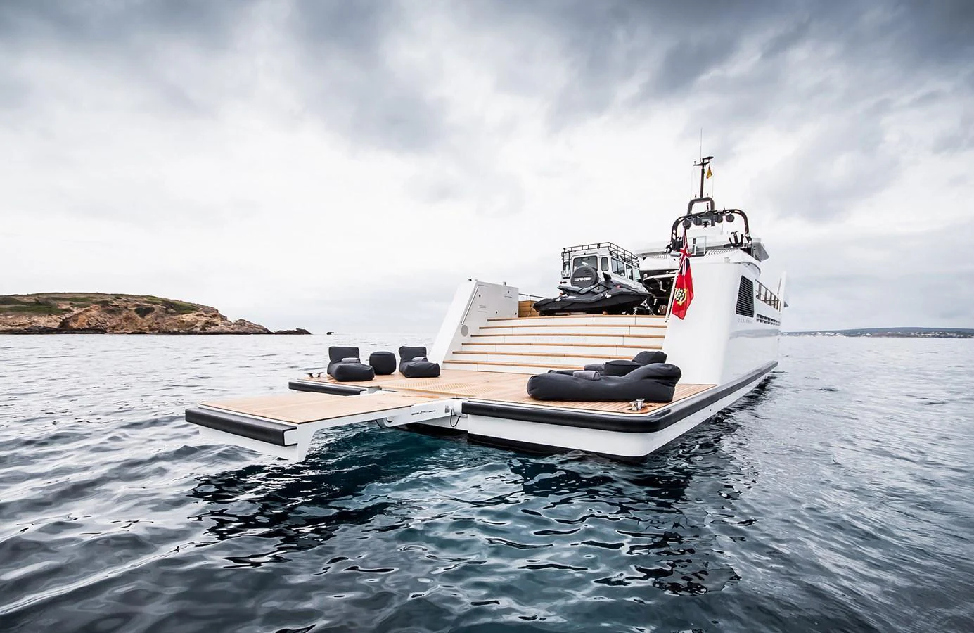 A sleek yacht with an extended swim platform and luxurious lounging area on calm waters. aboard 27 YXT Yacht for Sale