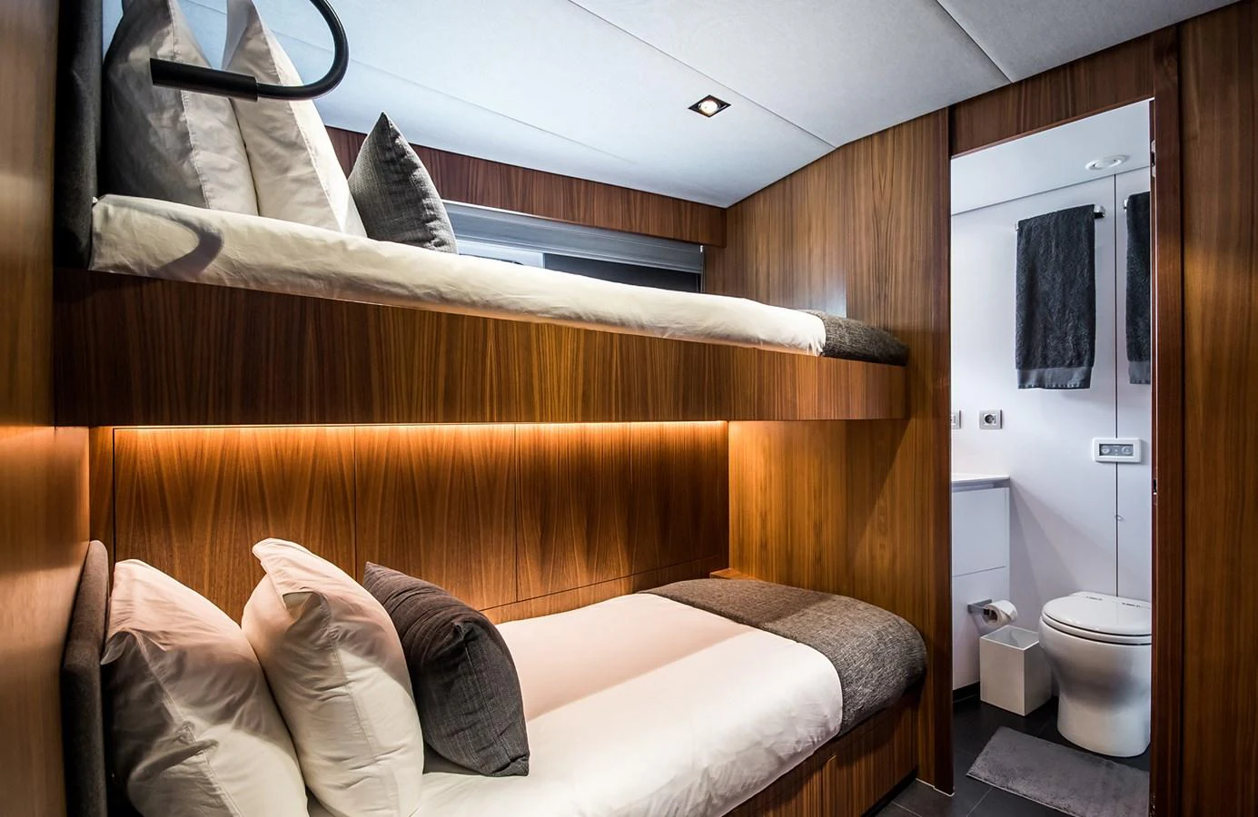 A cozy guest cabin with bunk beds and an en-suite bathroom. aboard 27 YXT Yacht for Sale