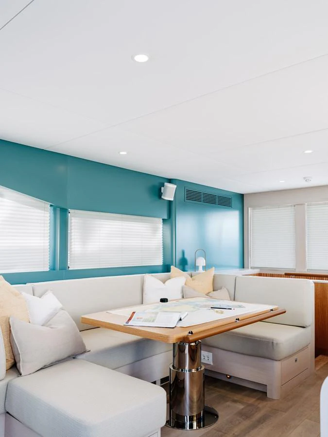 The salon features a cozy seating area with a table, perfect for relaxation and planning. aboard ARKSEN 85 Yacht for Sale