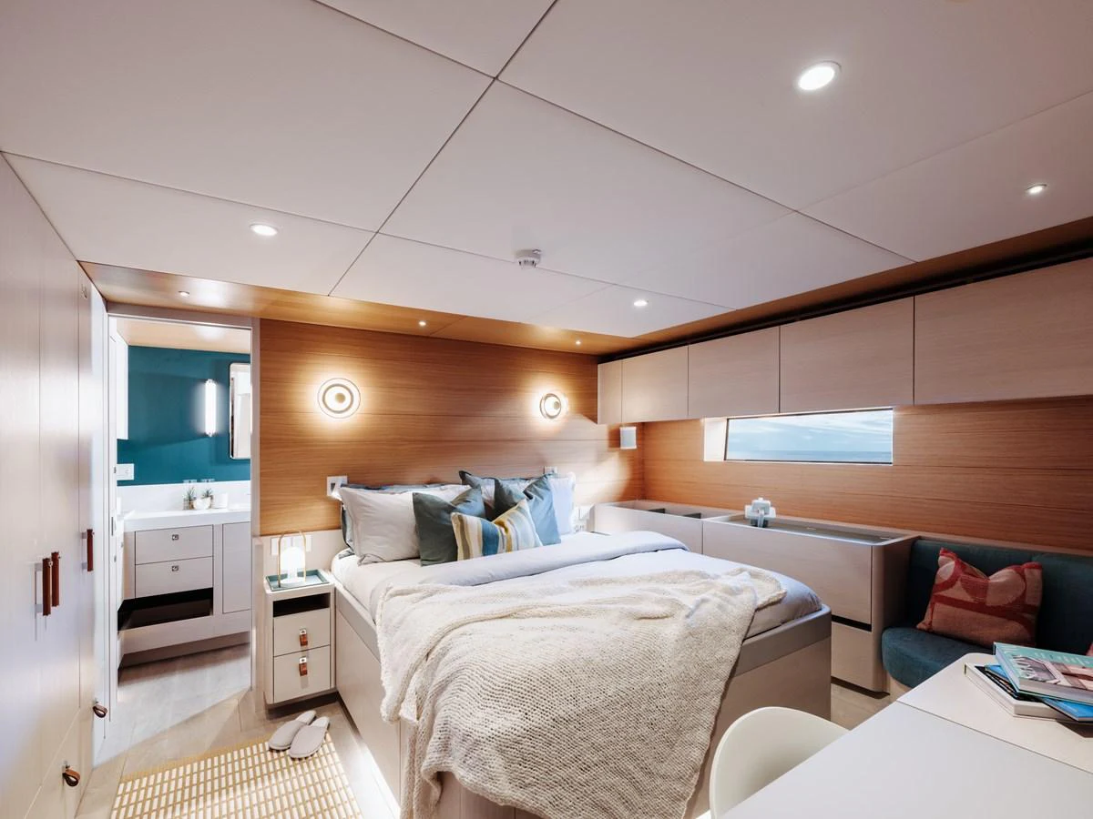 The stateroom features a cozy bed with plush pillows, modern lighting, and ample storage, creating a serene retreat. aboard ARKSEN 85 Yacht for Sale