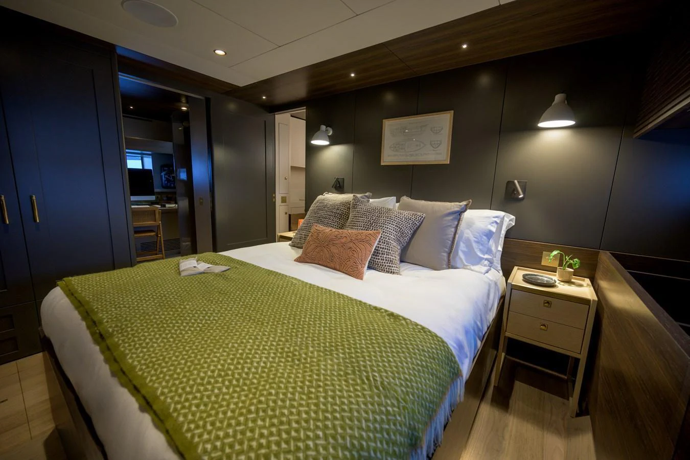 The stateroom features a cozy bed with elegant lighting and modern decor. aboard ARKSEN 85 Yacht for Sale