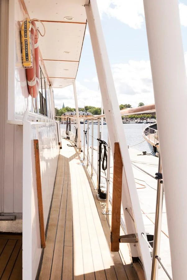 The side deck of the yacht offers a spacious walkway with a view of the surrounding marina. aboard STELLA NOVA Yacht for Sale