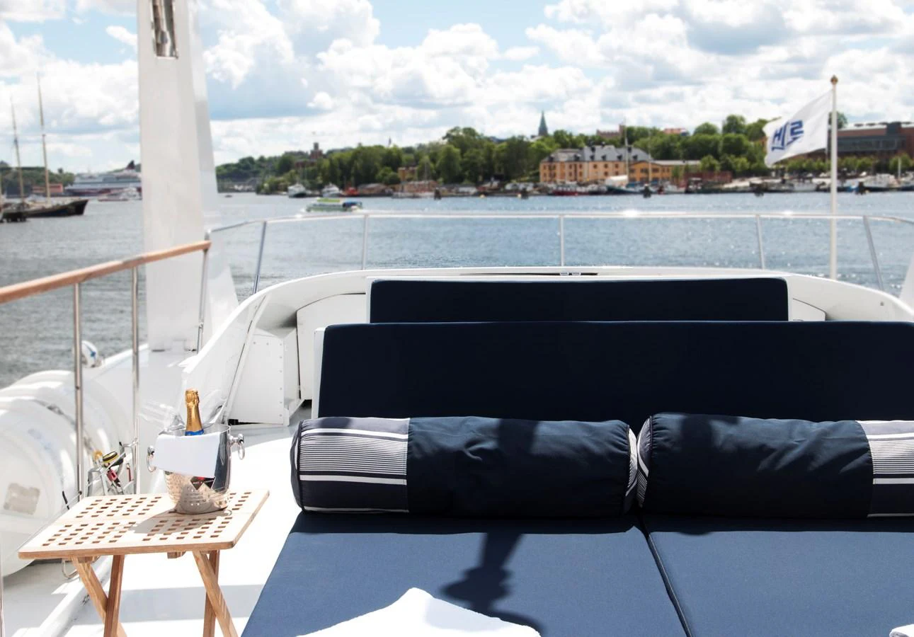 The sundeck offers a luxurious lounging area with plush cushions and a scenic view. aboard STELLA NOVA Yacht for Sale