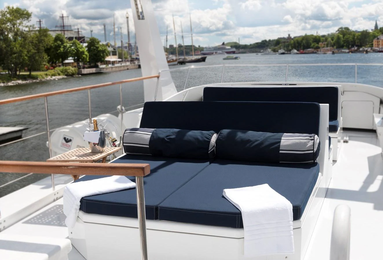The sundeck features luxurious sun loungers with plush cushions and a scenic view of the water. aboard STELLA NOVA Yacht for Sale
