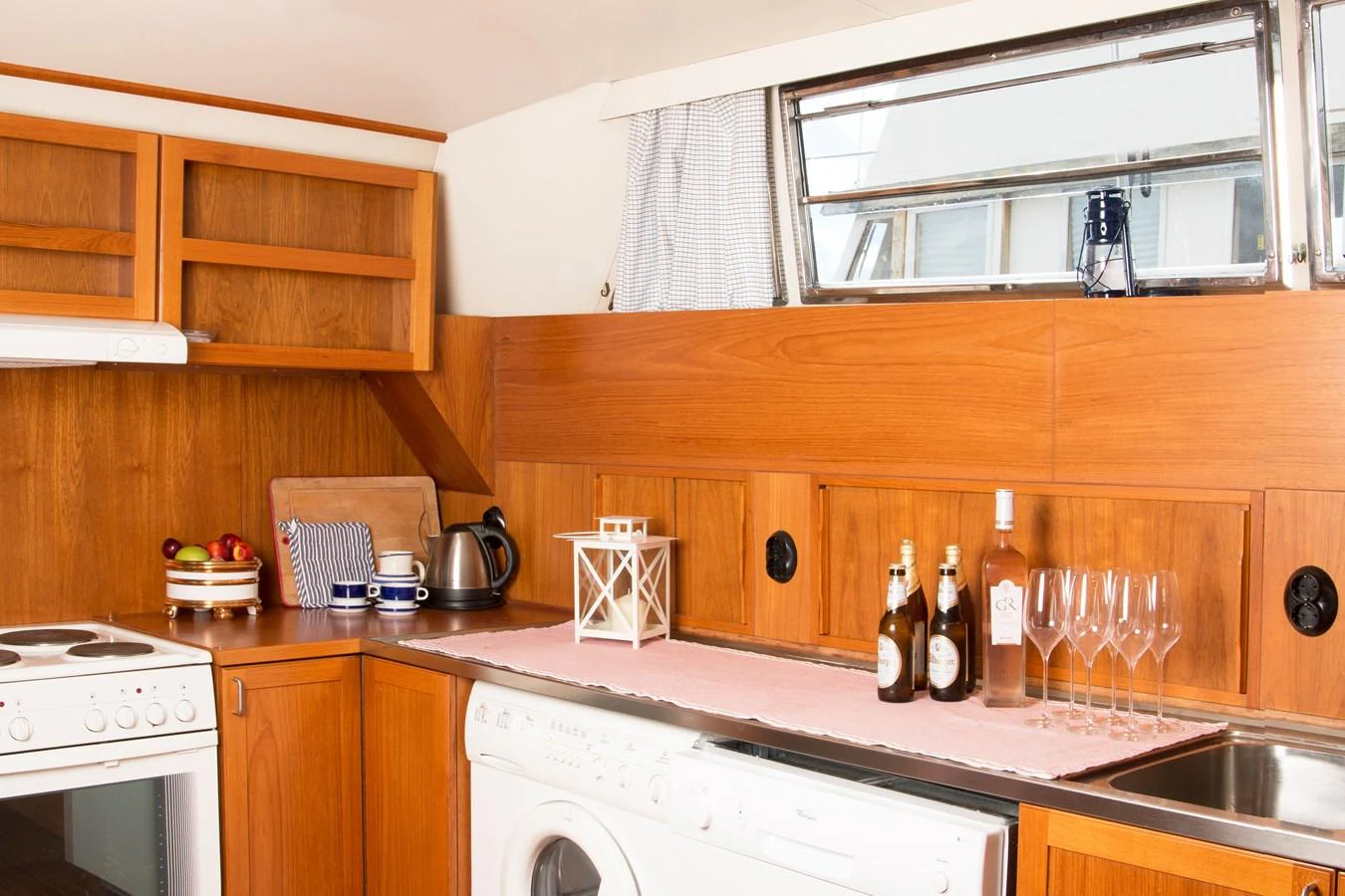 The yacht's galley features wooden cabinetry, modern appliances, and a cozy atmosphere. aboard STELLA NOVA Yacht for Sale