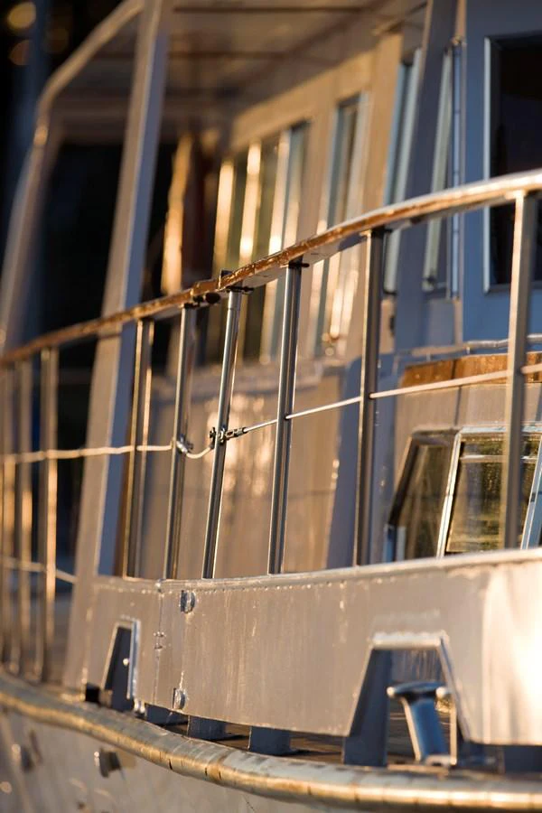 A close-up view of the yacht's railing and windows, showcasing its craftsmanship. aboard STELLA NOVA Yacht for Sale