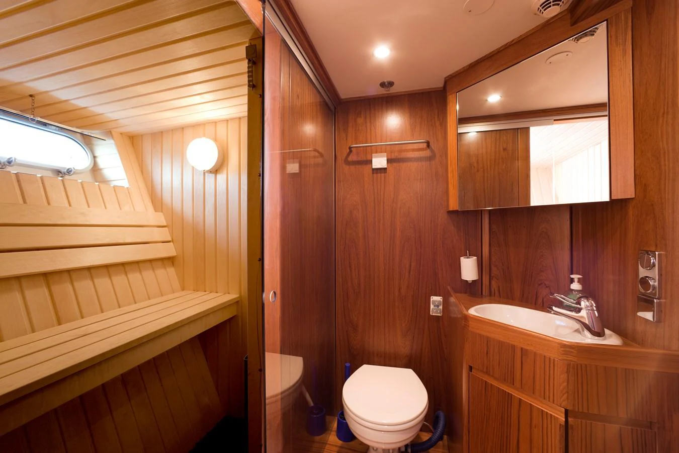 The yacht's bathroom features elegant wood paneling and modern fixtures. aboard STELLA NOVA Yacht for Sale