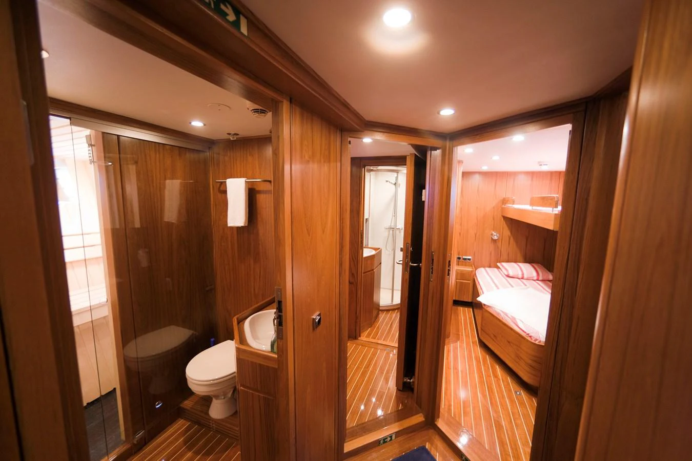 The image showcases a warm and inviting guest cabin with wooden finishes and modern amenities. aboard STELLA NOVA Yacht for Sale