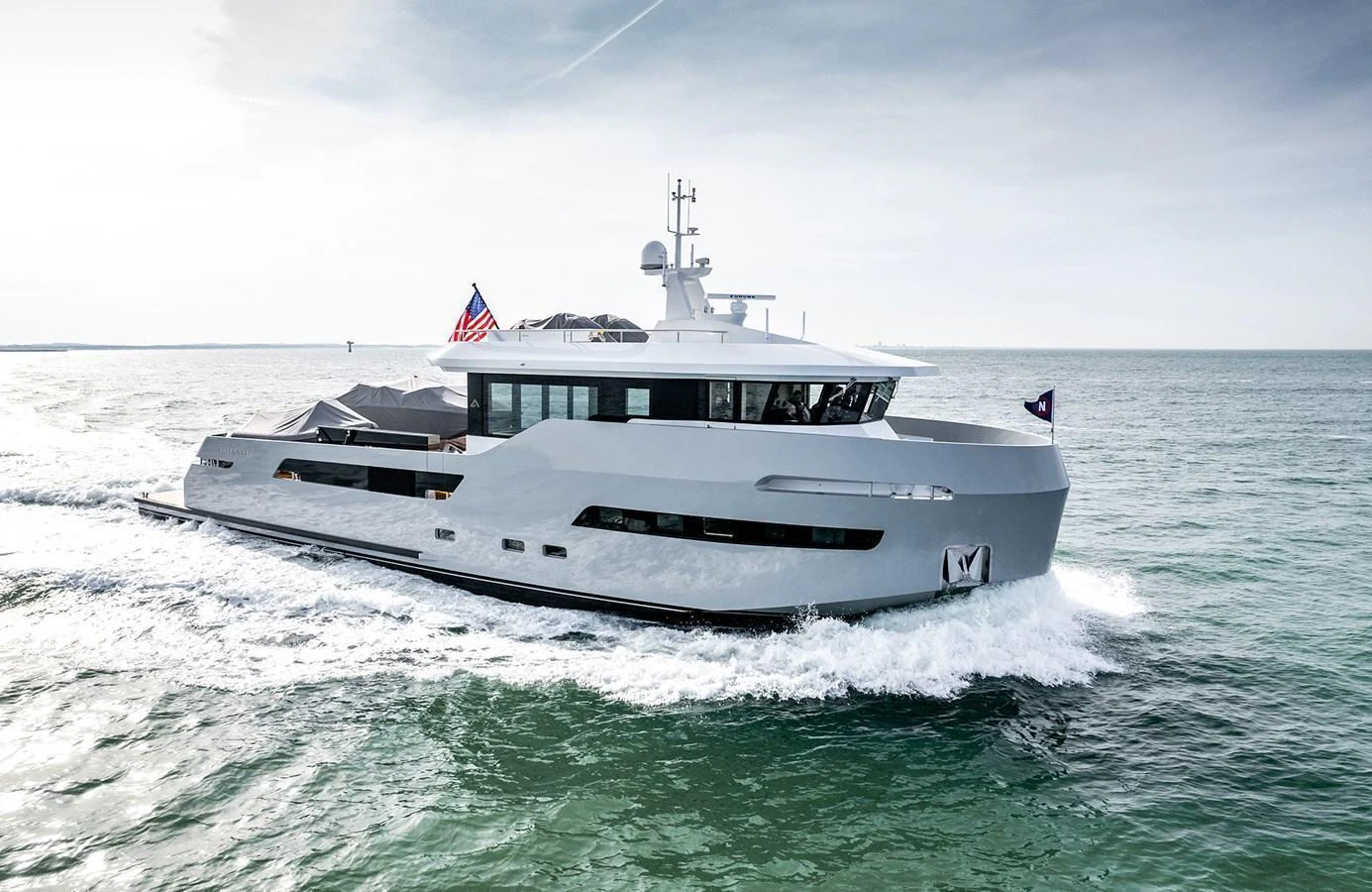 A sleek and modern yacht cruising on open waters under a clear sky. aboard 27 CROSSOVER Yacht for Sale