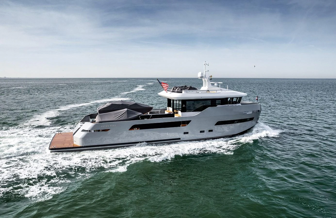 A sleek and modern yacht cruises smoothly on open waters, showcasing its elegant design and spacious deck areas. aboard 27 CROSSOVER Yacht for Sale