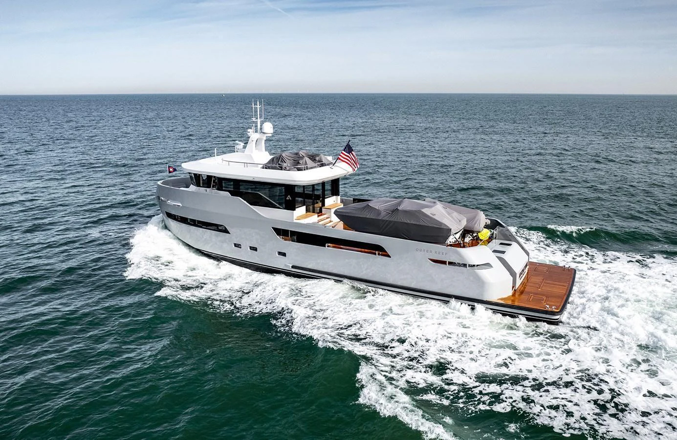 A sleek and modern yacht cruising on open waters with an elegant design and spacious deck areas. aboard 27 CROSSOVER Yacht for Sale