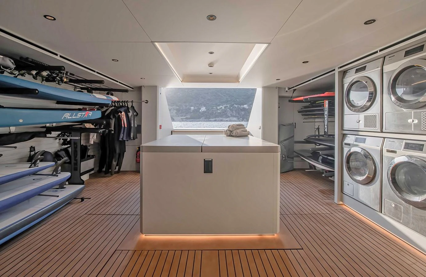 The yacht's interior features a well-equipped utility room with laundry facilities and storage for water sports equipment. aboard 27 CROSSOVER Yacht for Sale