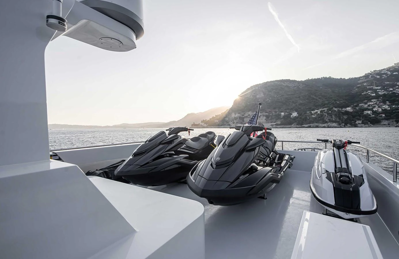 The yacht features a collection of sleek jet skis on its deck, ready for thrilling water adventures. aboard 27 CROSSOVER Yacht for Sale