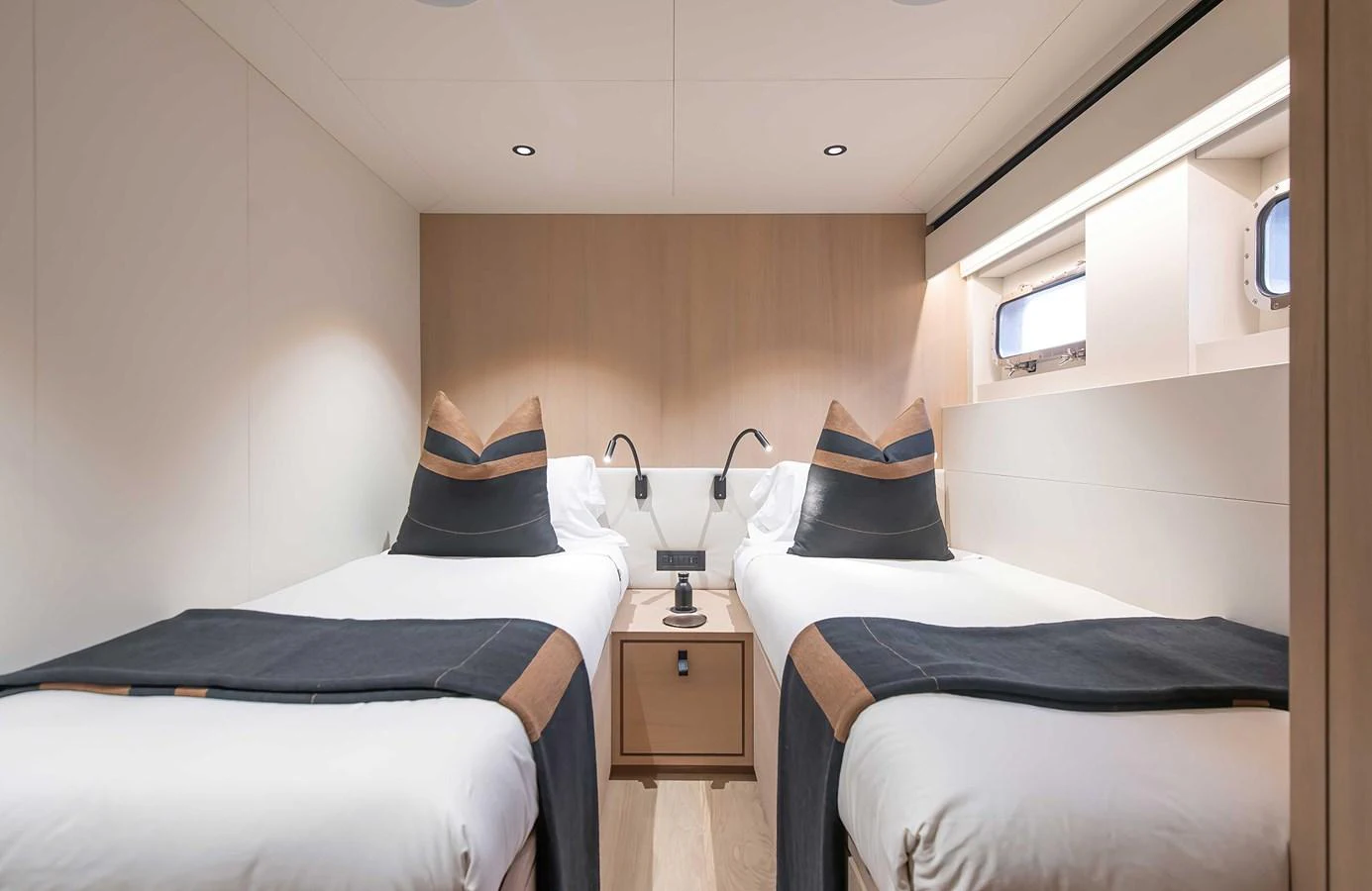The twin stateroom offers a cozy and elegant sleeping area with modern amenities. aboard 27 CROSSOVER Yacht for Sale