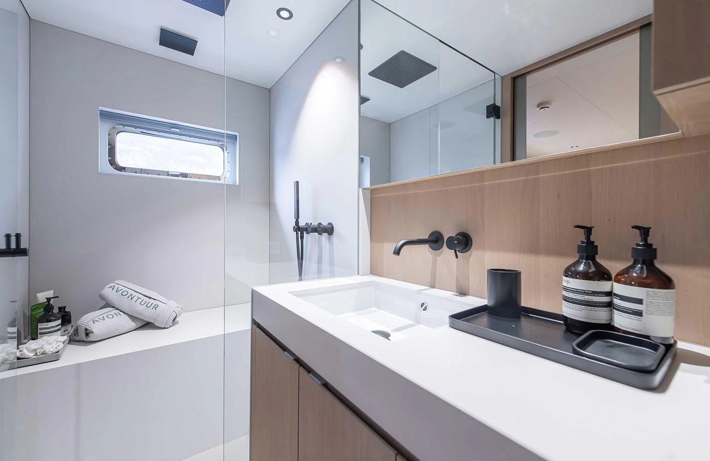 The yacht's bathroom features a sleek, modern design with high-end fixtures and ample natural light. aboard 27 CROSSOVER Yacht for Sale