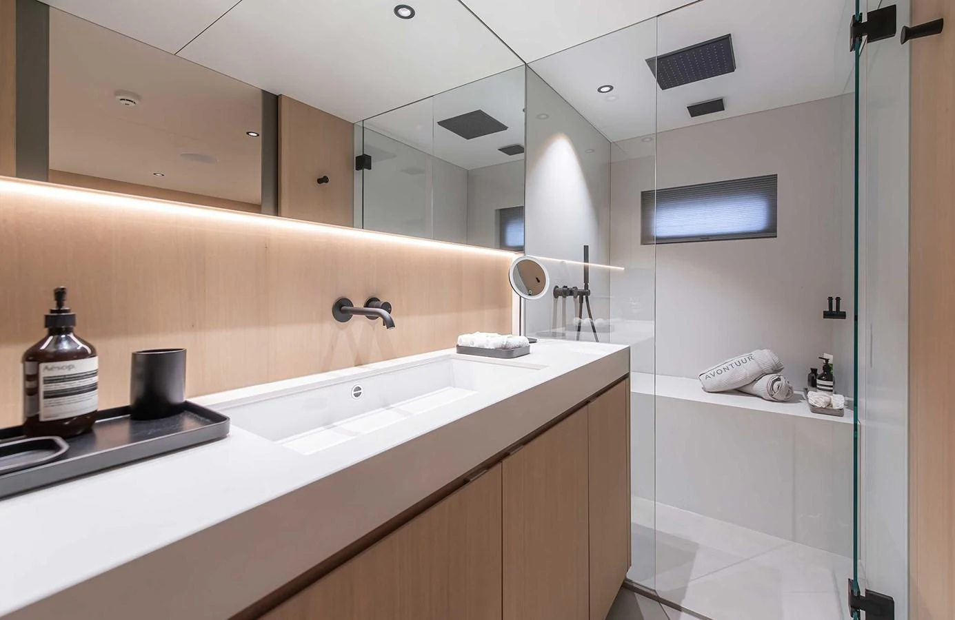 The yacht's bathroom features modern fixtures and a sleek, minimalist design. aboard 27 CROSSOVER Yacht for Sale