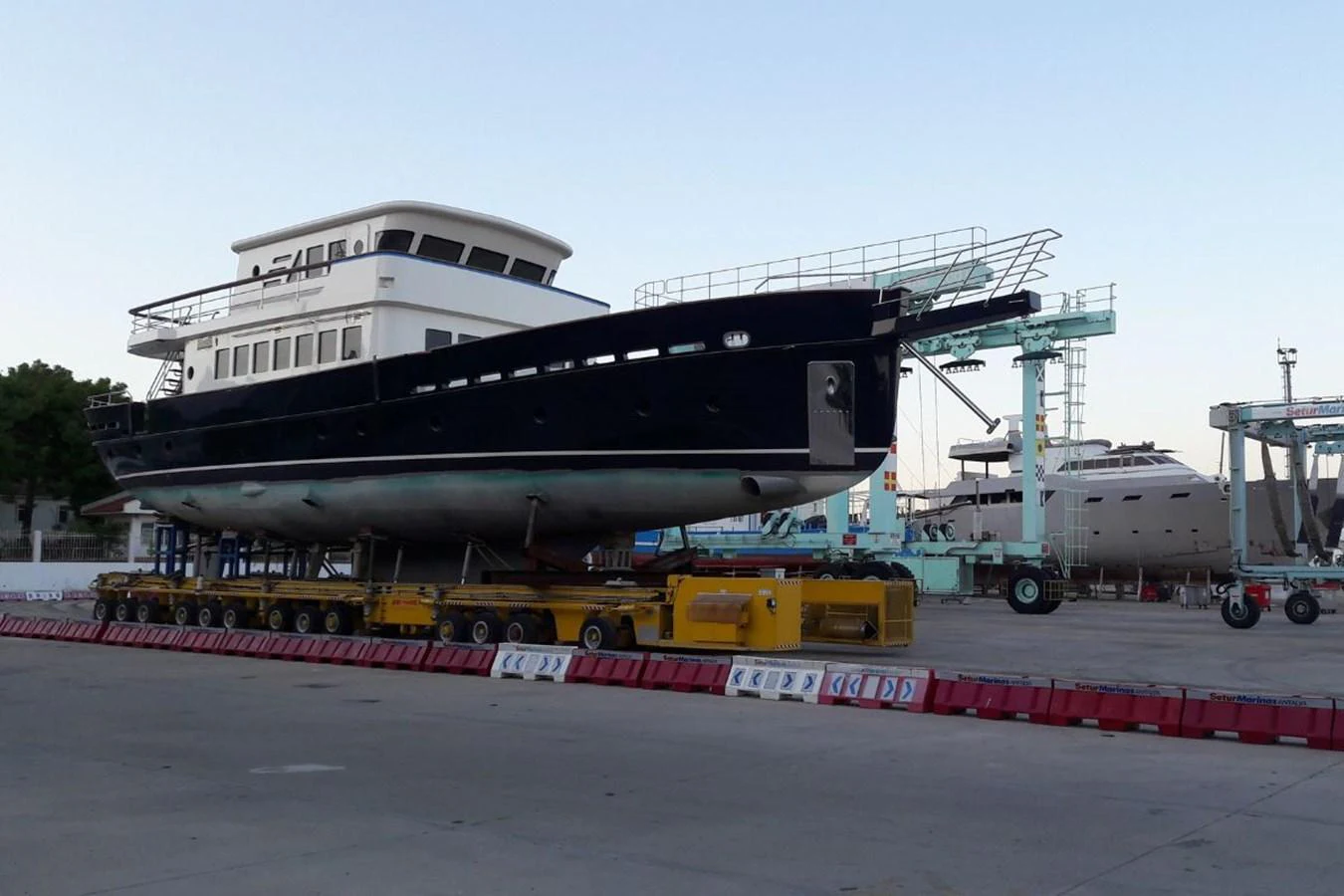 The yacht is seen on land, undergoing maintenance or construction in a shipyard. aboard SVETLANA Yacht for Sale