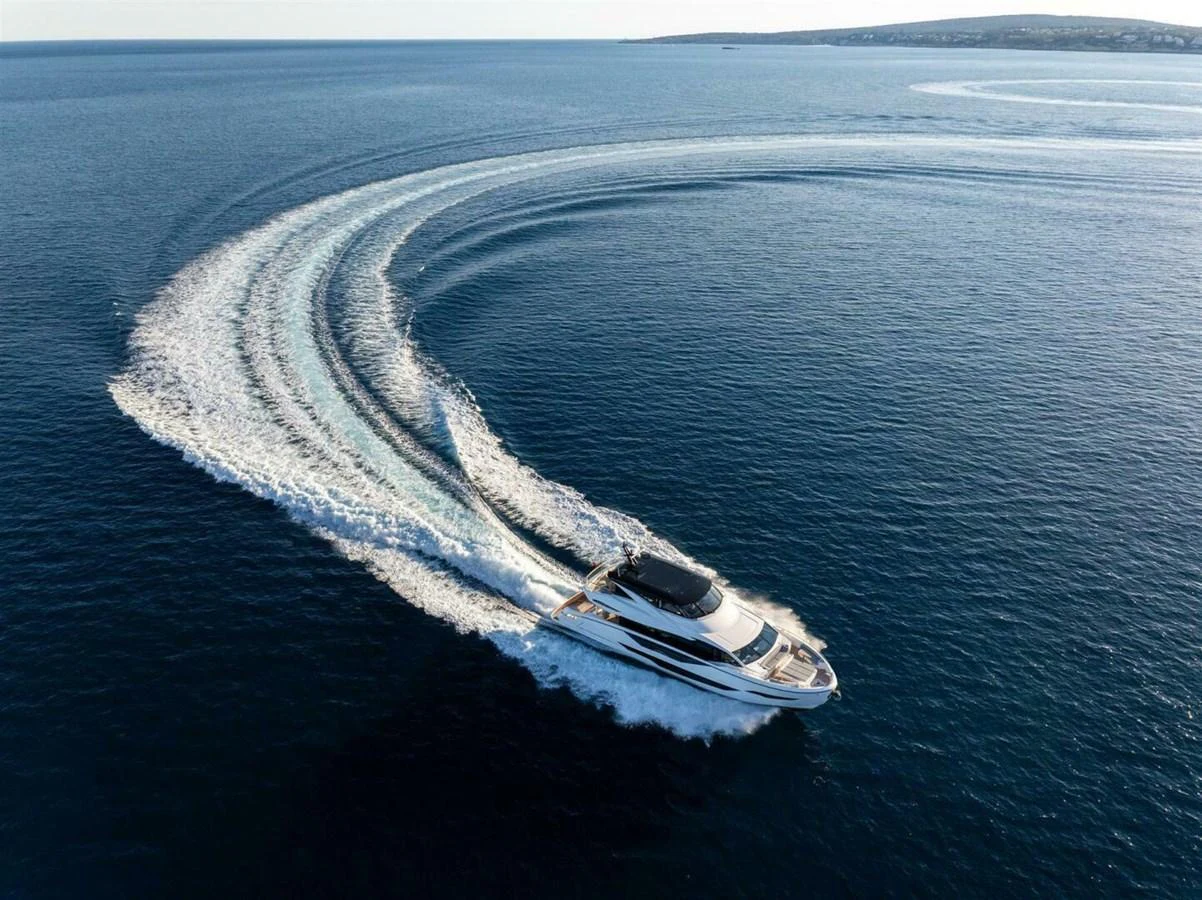 A sleek yacht glides swiftly through the open sea, leaving a graceful wake behind. aboard 90 OCEAN ENCLOSED Yacht for Sale