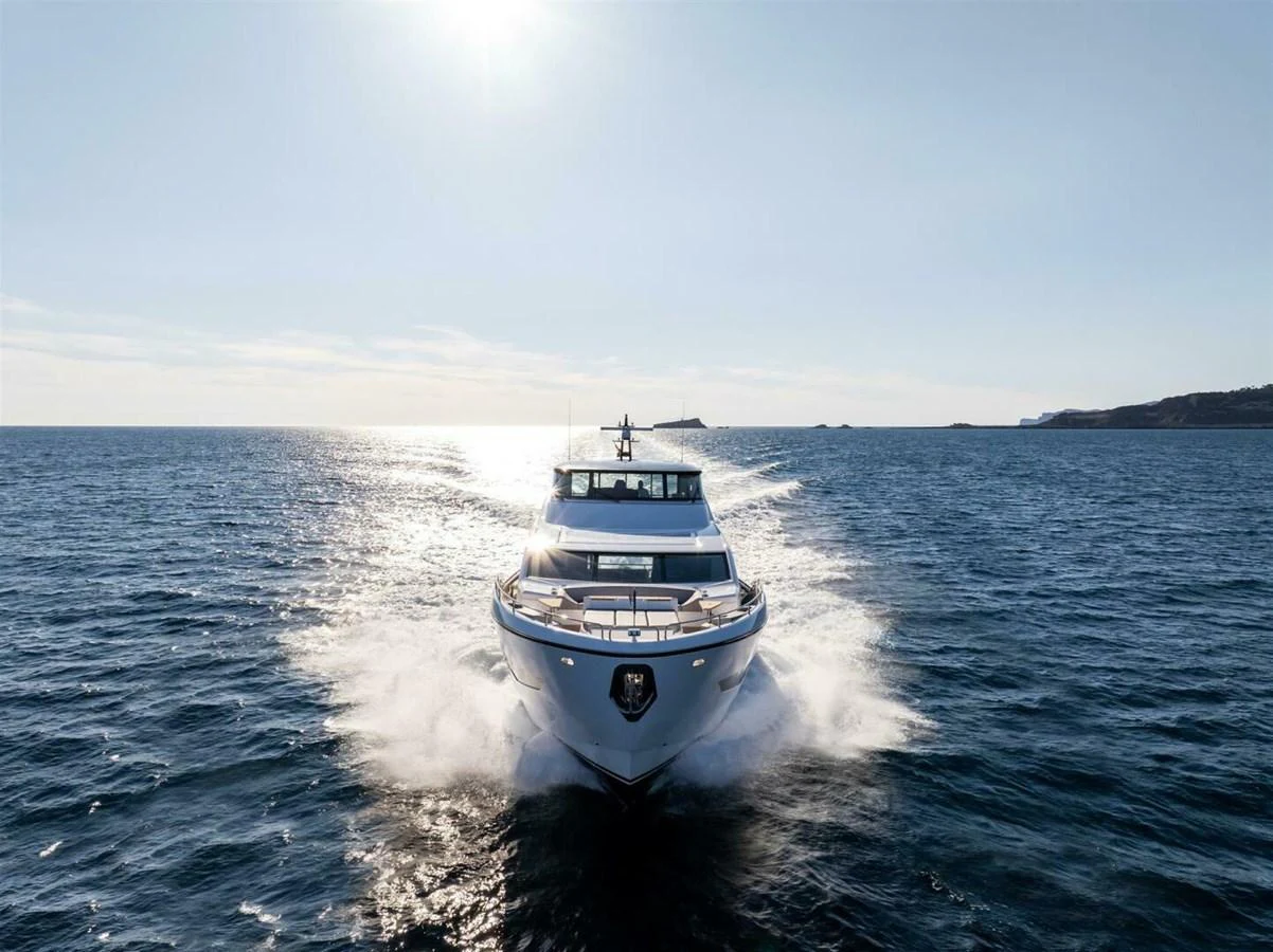 A stunning yacht cruises through open waters, showcasing its sleek design and powerful performance. aboard 90 OCEAN ENCLOSED Yacht for Sale