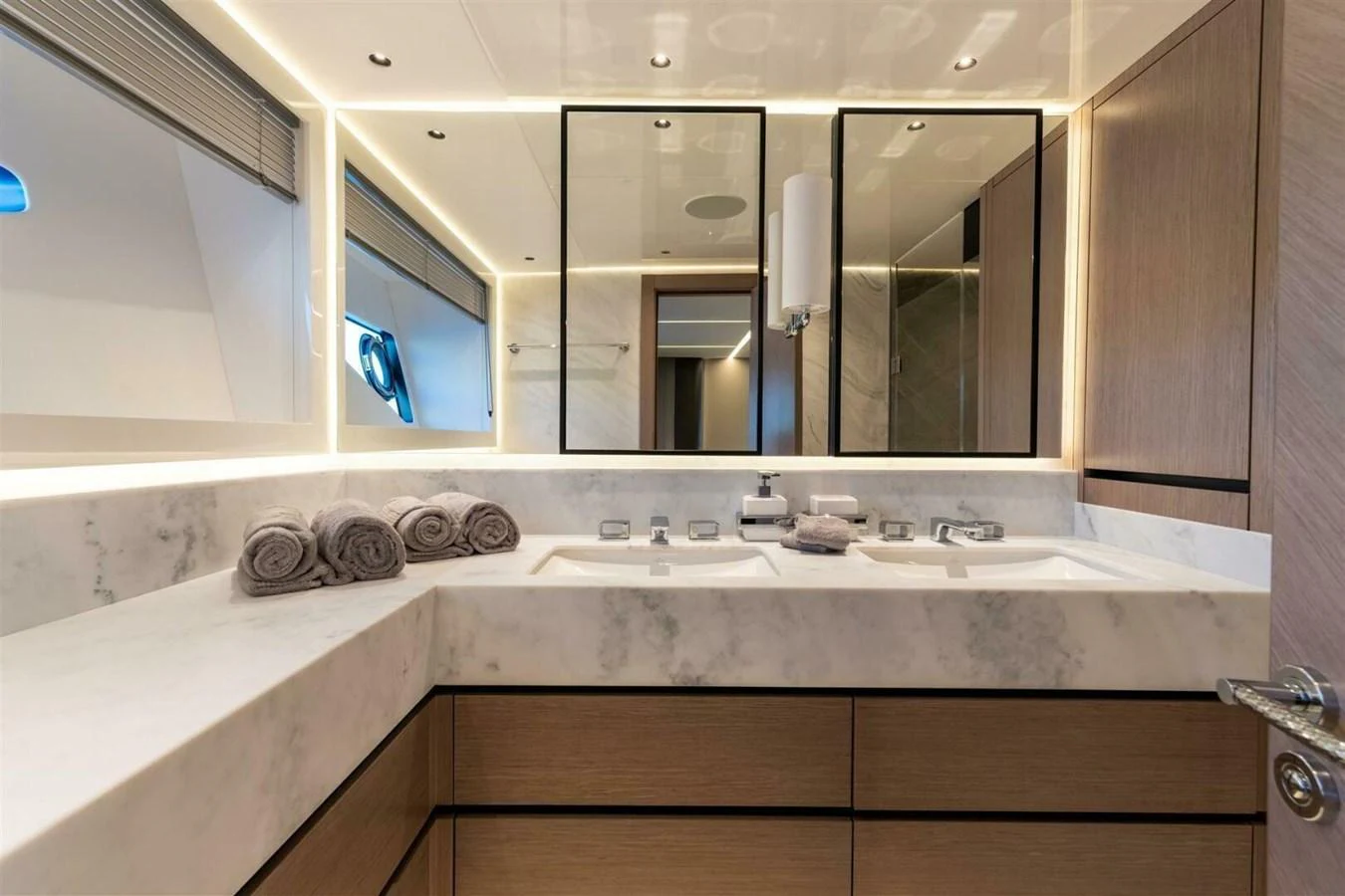 The yacht's bathroom features a sleek, modern design with dual sinks and ample lighting. aboard 90 OCEAN ENCLOSED Yacht for Sale
