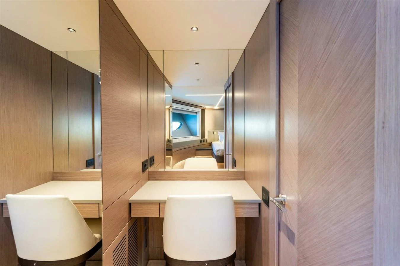 The stateroom features a sleek vanity area with a comfortable chair and ample mirror space. aboard 90 OCEAN ENCLOSED Yacht for Sale
