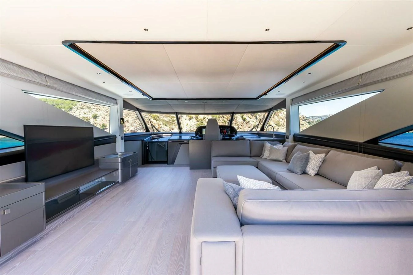 The spacious salon features modern furnishings and expansive windows offering stunning views. aboard 90 OCEAN ENCLOSED Yacht for Sale
