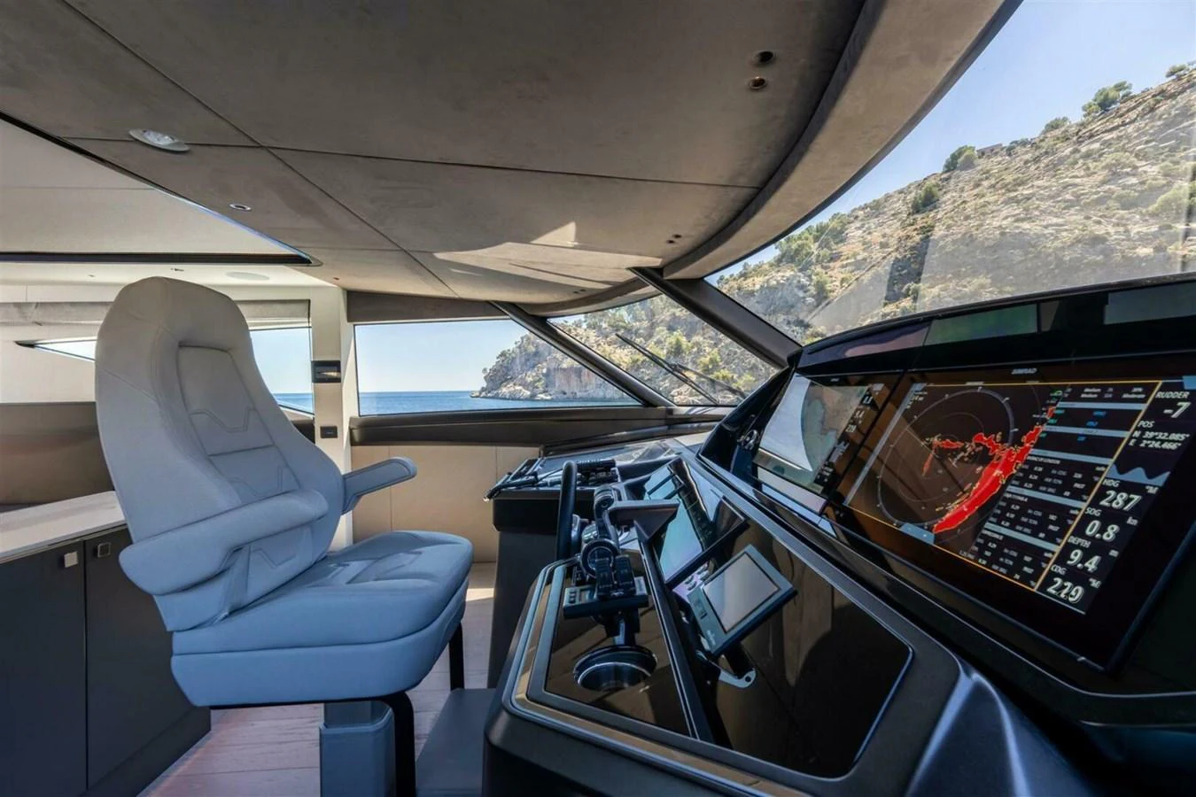 The helm station offers a sleek and modern design with advanced navigation equipment and a comfortable captain's chair. aboard 90 OCEAN ENCLOSED Yacht for Sale