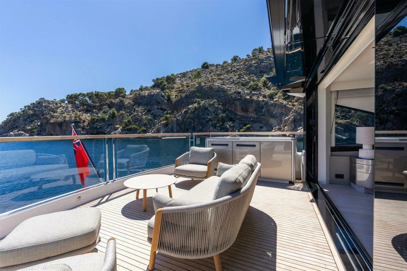 The aft deck offers a serene outdoor lounging area with comfortable seating and stunning views. aboard 90 OCEAN ENCLOSED Yacht for Sale