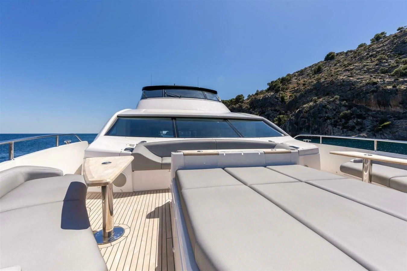 The foredeck of this yacht offers spacious sun pads and a sleek, modern design. aboard 90 OCEAN ENCLOSED Yacht for Sale