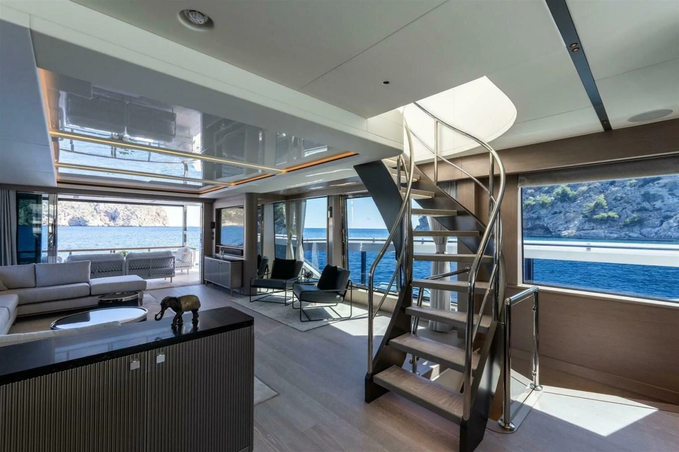The yacht's salon features modern furnishings with expansive windows offering stunning ocean views. aboard 90 OCEAN ENCLOSED Yacht for Sale