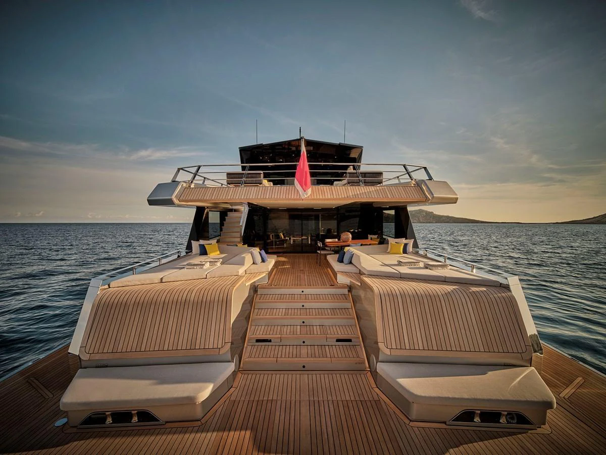 The yacht's aft deck features luxurious sun loungers and a spacious seating area, perfect for relaxation and enjoying the sea view. aboard WALLYWHY200 Yacht for Sale