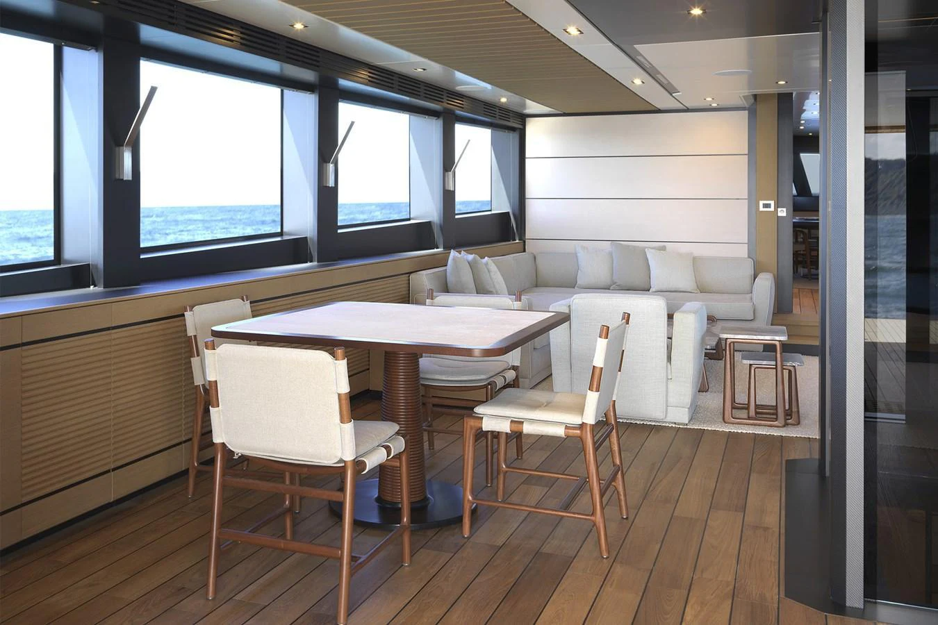 The salon features a stylish seating area with a dining table and panoramic windows offering ocean views. aboard WALLYWHY200 Yacht for Sale