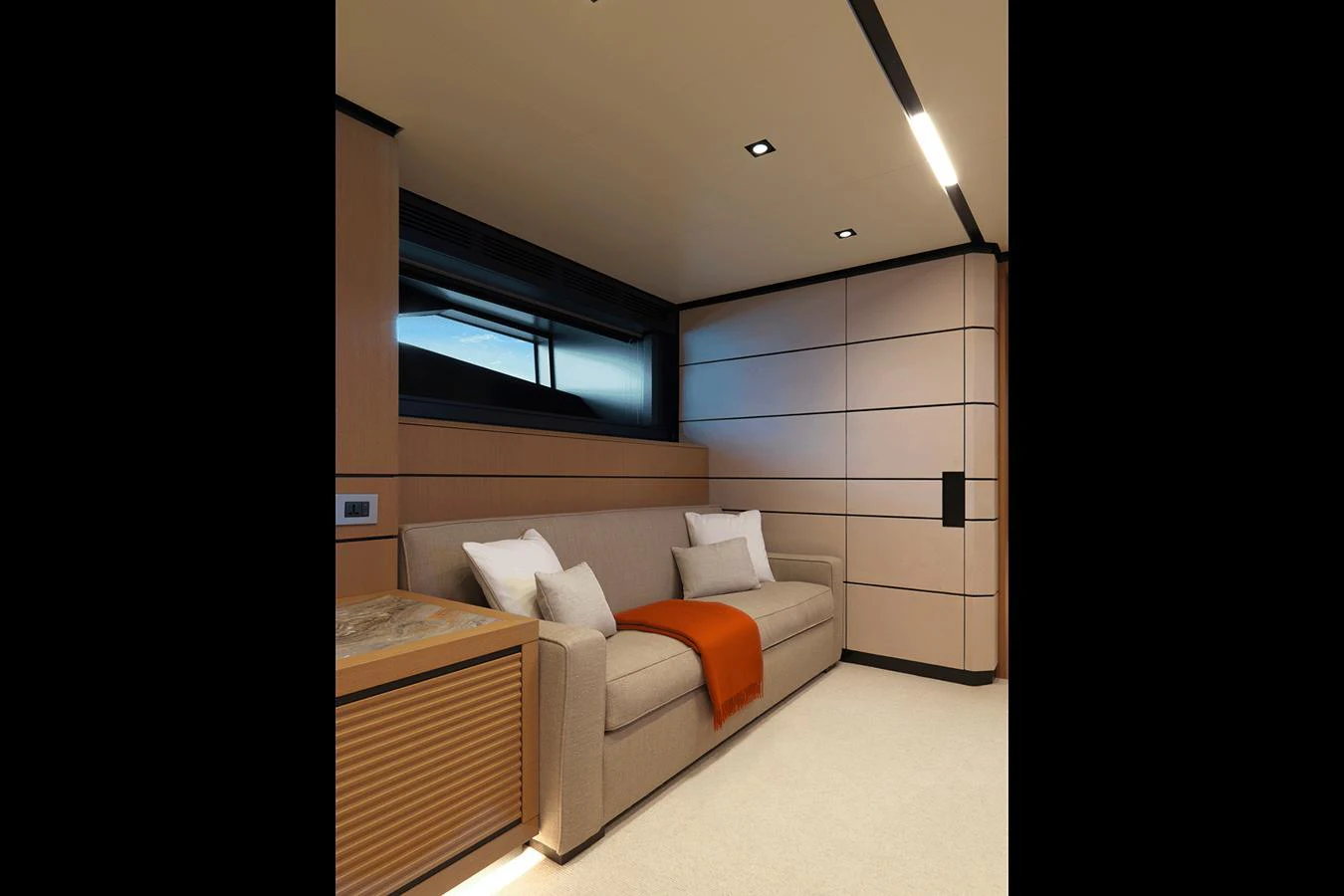 The salon features a comfortable sofa with elegant cushions and a stylish throw blanket. aboard WALLYWHY200 Yacht for Sale