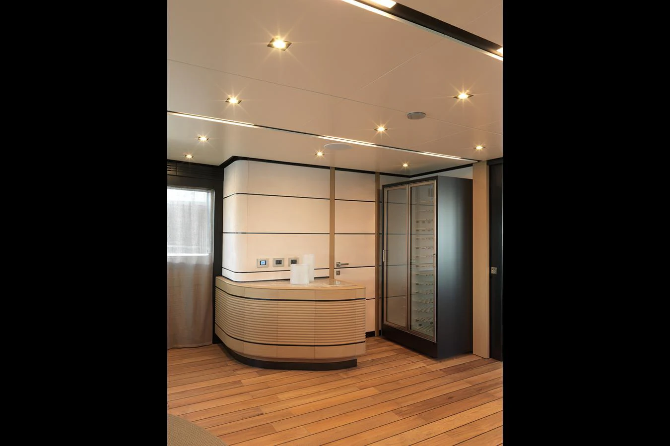 A modern yacht interior with sleek wood flooring and contemporary lighting. aboard WALLYWHY200 Yacht for Sale