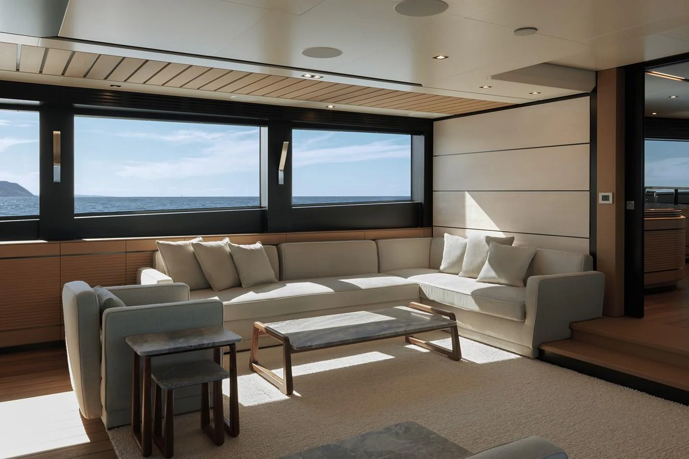 The yacht's salon features a spacious and elegant seating area with large windows offering stunning ocean views. aboard WALLYWHY200 Yacht for Sale