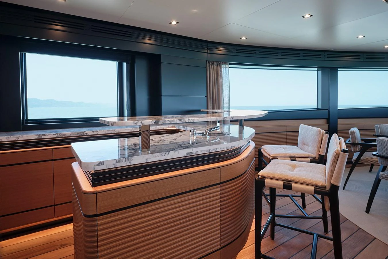 The yacht's galley features a sleek, modern design with ample seating and large windows offering stunning views. aboard WALLYWHY200 Yacht for Sale