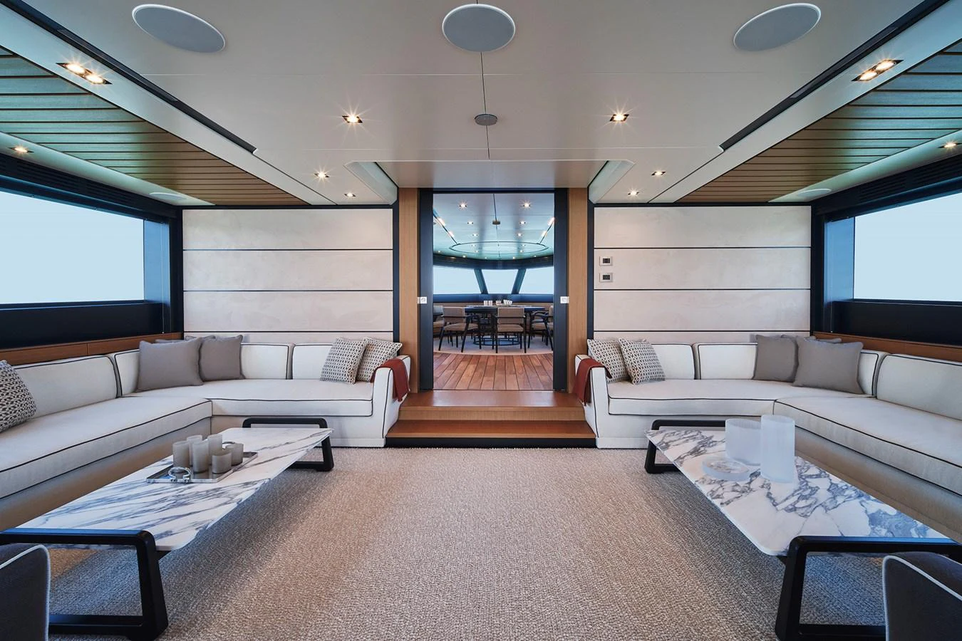The salon features elegant seating with a view towards the dining area. aboard WALLYWHY200 Yacht for Sale