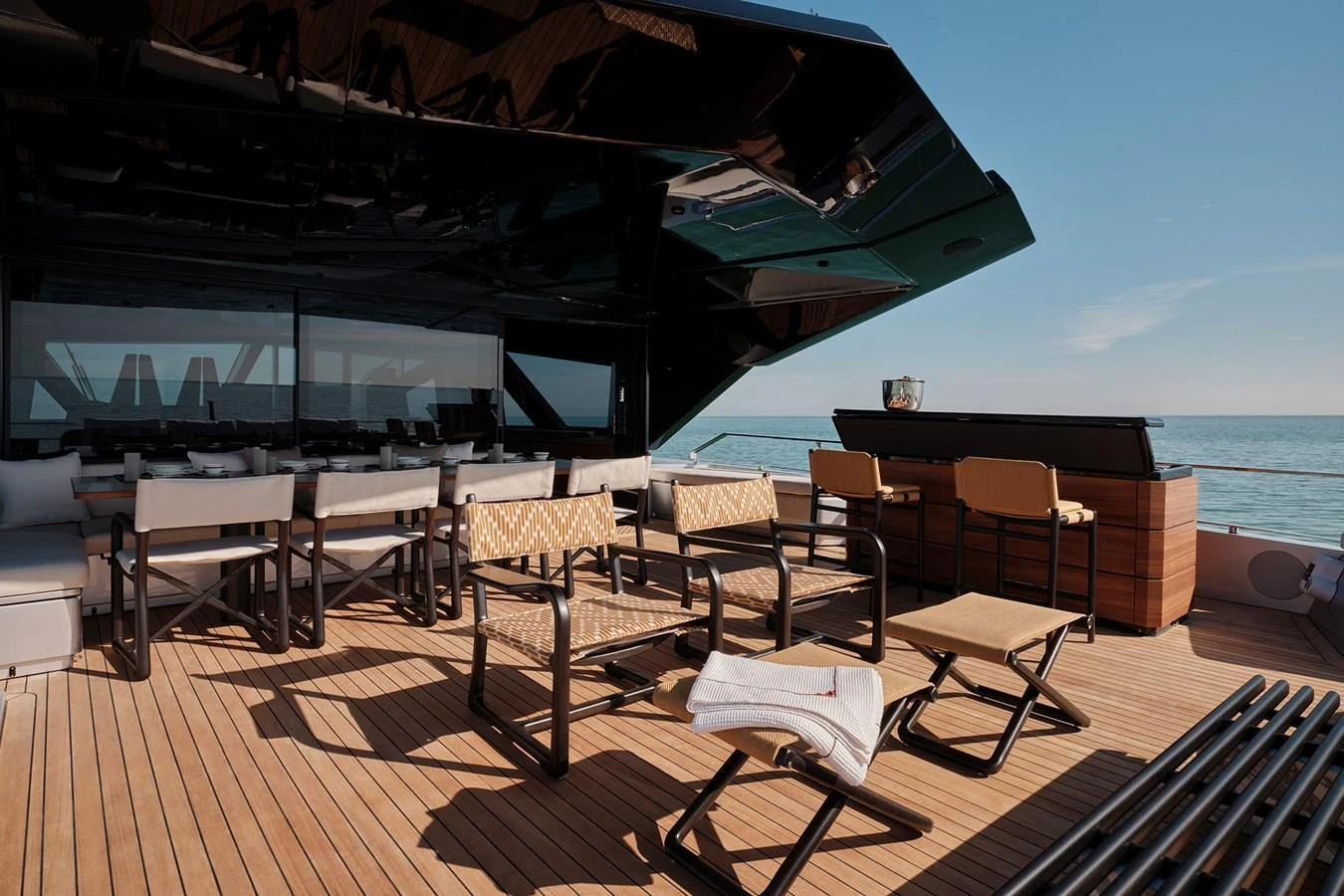 The aft deck offers a spacious and stylish outdoor area with comfortable seating and a bar, perfect for relaxation and entertainment. aboard WALLYWHY200 Yacht for Sale
