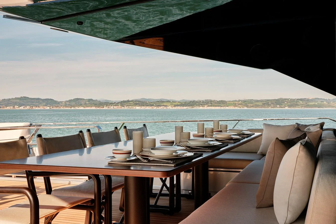 The aft deck features an elegant dining area with a stunning sea view. aboard WALLYWHY200 Yacht for Sale