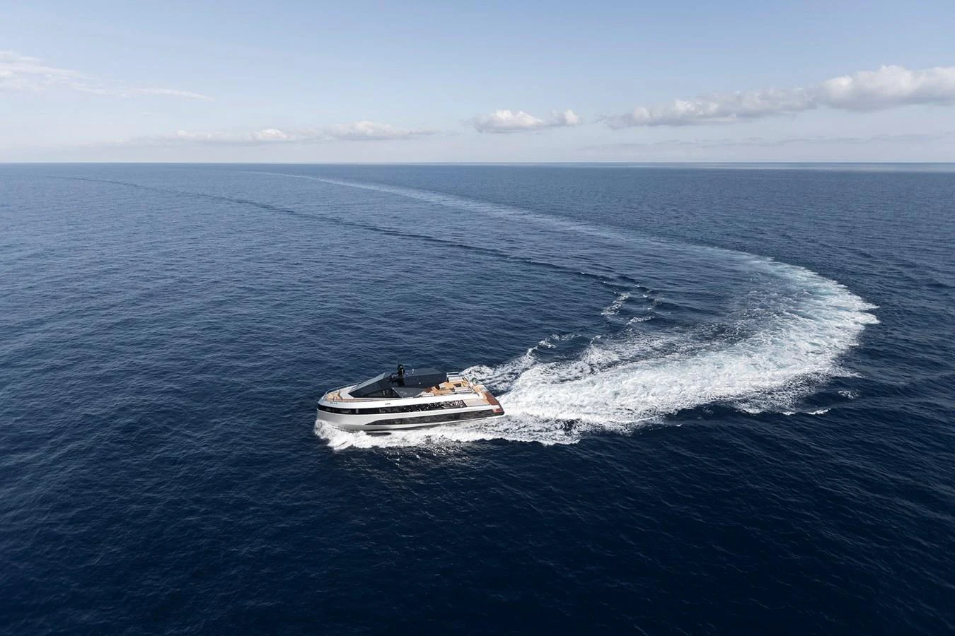 A sleek yacht glides through the open sea, leaving a graceful wake behind. aboard WALLYWHY200 Yacht for Sale