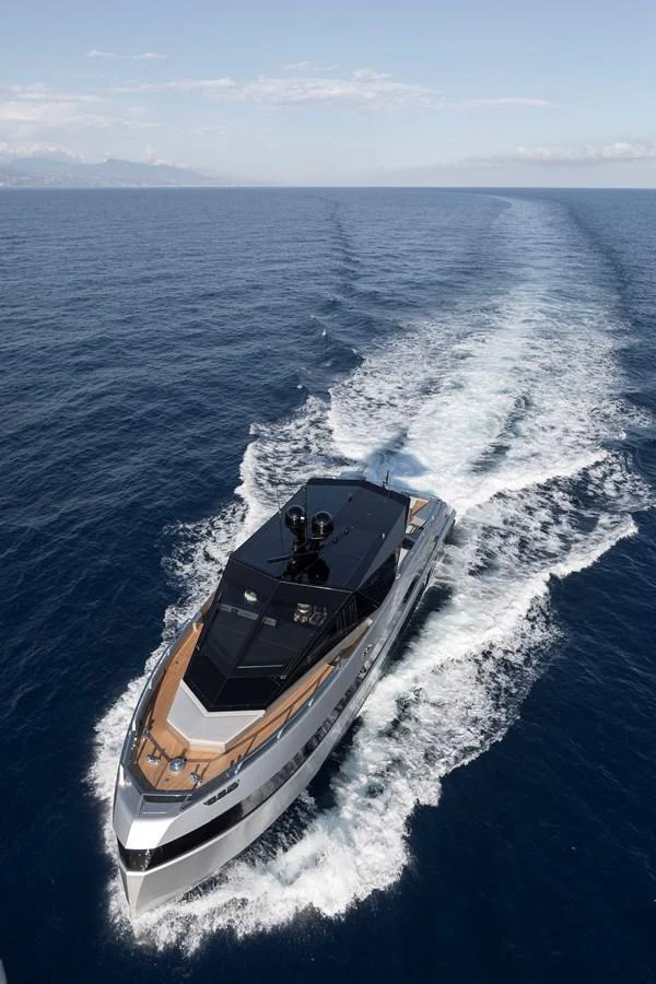 A sleek yacht cruises through the open sea, leaving a trail of white wake behind. aboard WALLYWHY200 Yacht for Sale