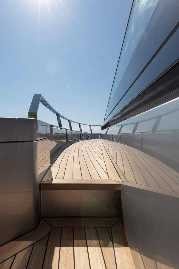 The sleek deck of the yacht showcases modern design and high-quality materials under a clear blue sky. aboard WALLYWHY200 Yacht for Sale