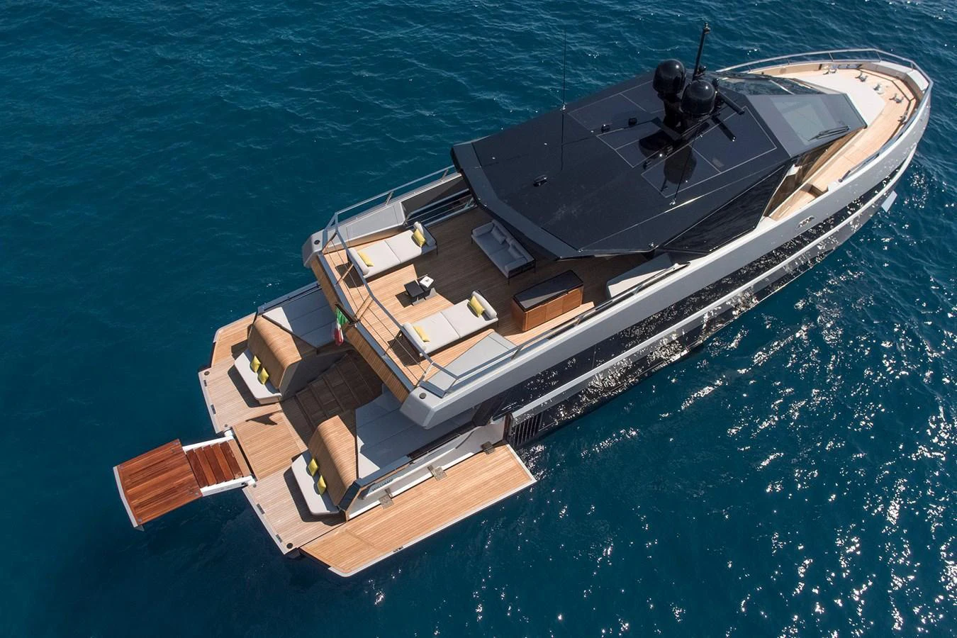 A sleek and modern yacht cruising on clear blue waters, showcasing its spacious aft deck and luxurious amenities. aboard WALLYWHY200 Yacht for Sale