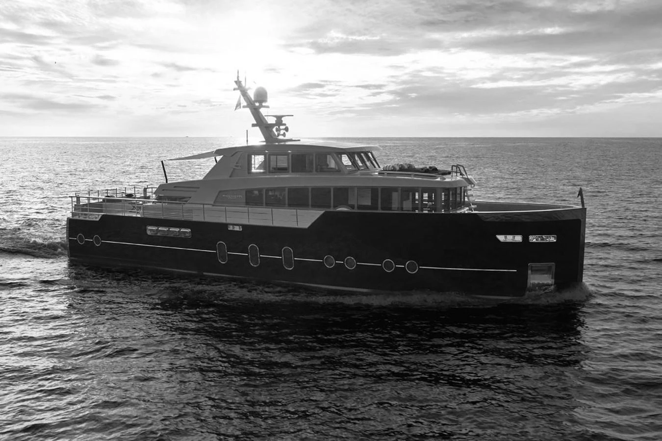 A sleek, modern yacht cruises gracefully on the open water at sunset. aboard PICCHIOTTI 24 Yacht for Sale