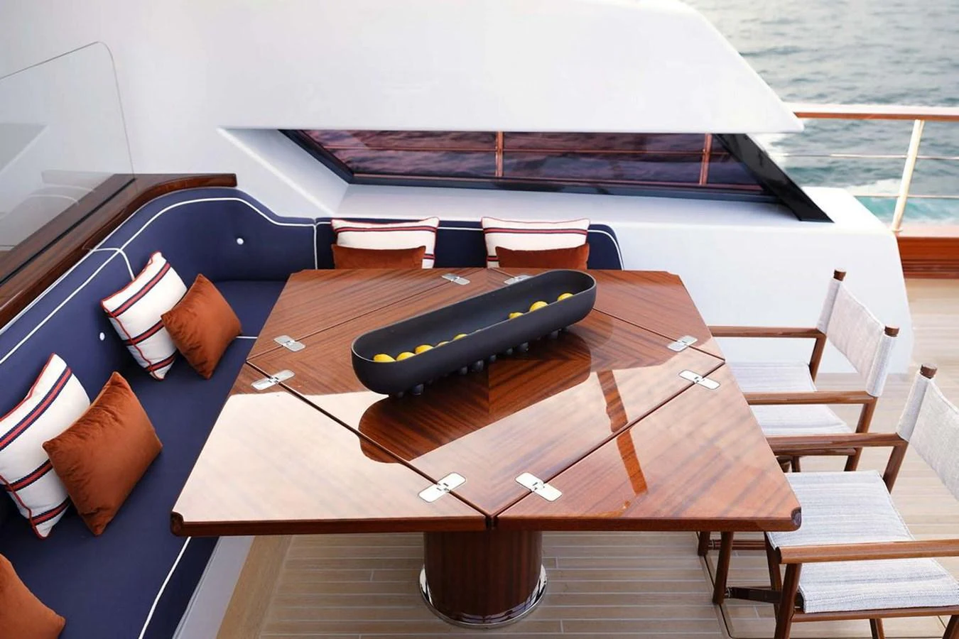 The aft deck features a stylish dining area with a polished wooden table and comfortable seating, perfect for alfresco meals. aboard PICCHIOTTI 24 Yacht for Sale