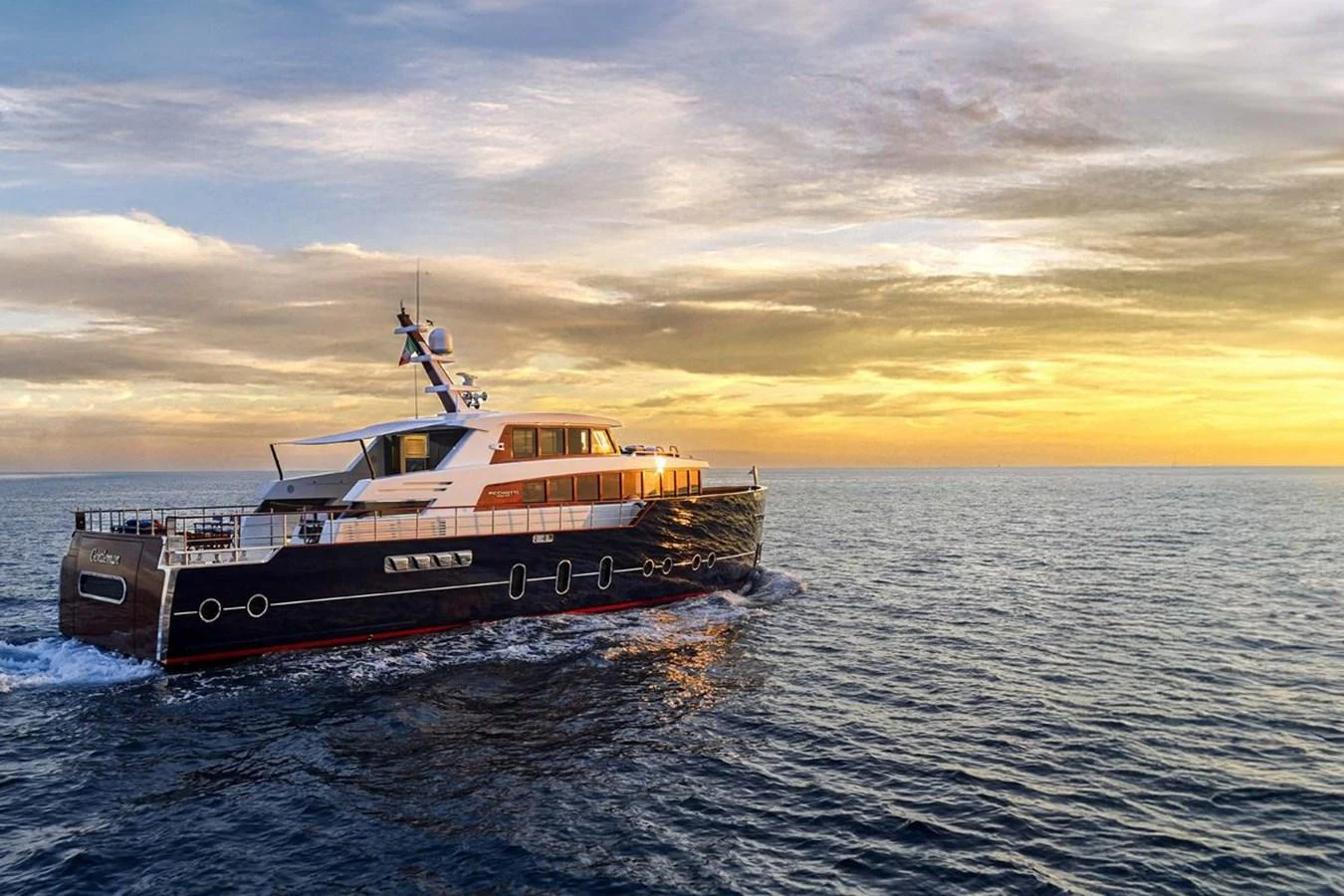A luxurious yacht cruises through calm waters at sunset, showcasing its elegant design and spacious deck. aboard PICCHIOTTI 24 Yacht for Sale