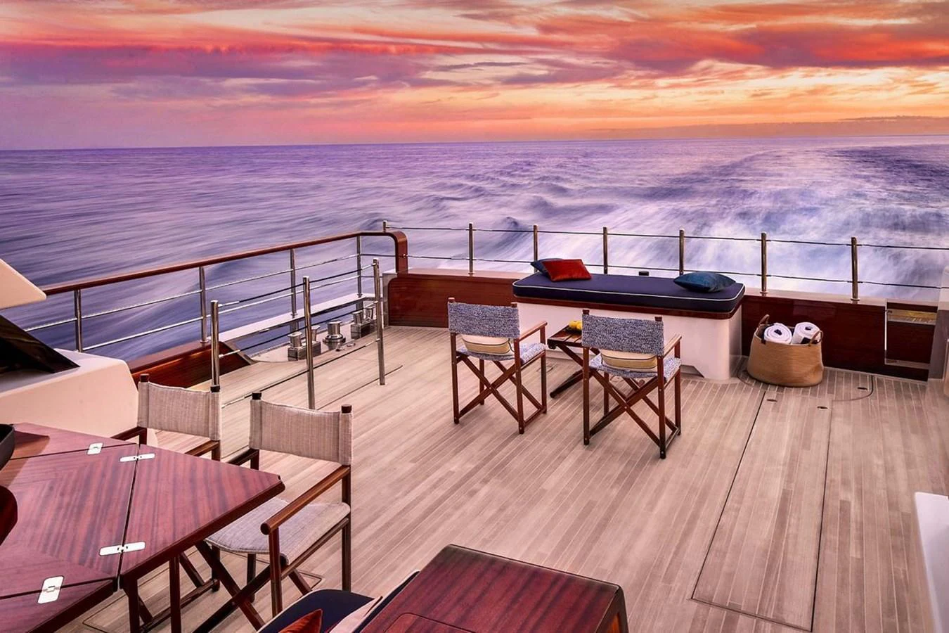 The aft deck offers a serene setting with comfortable seating and a stunning ocean view at sunset. aboard PICCHIOTTI 24 Yacht for Sale
