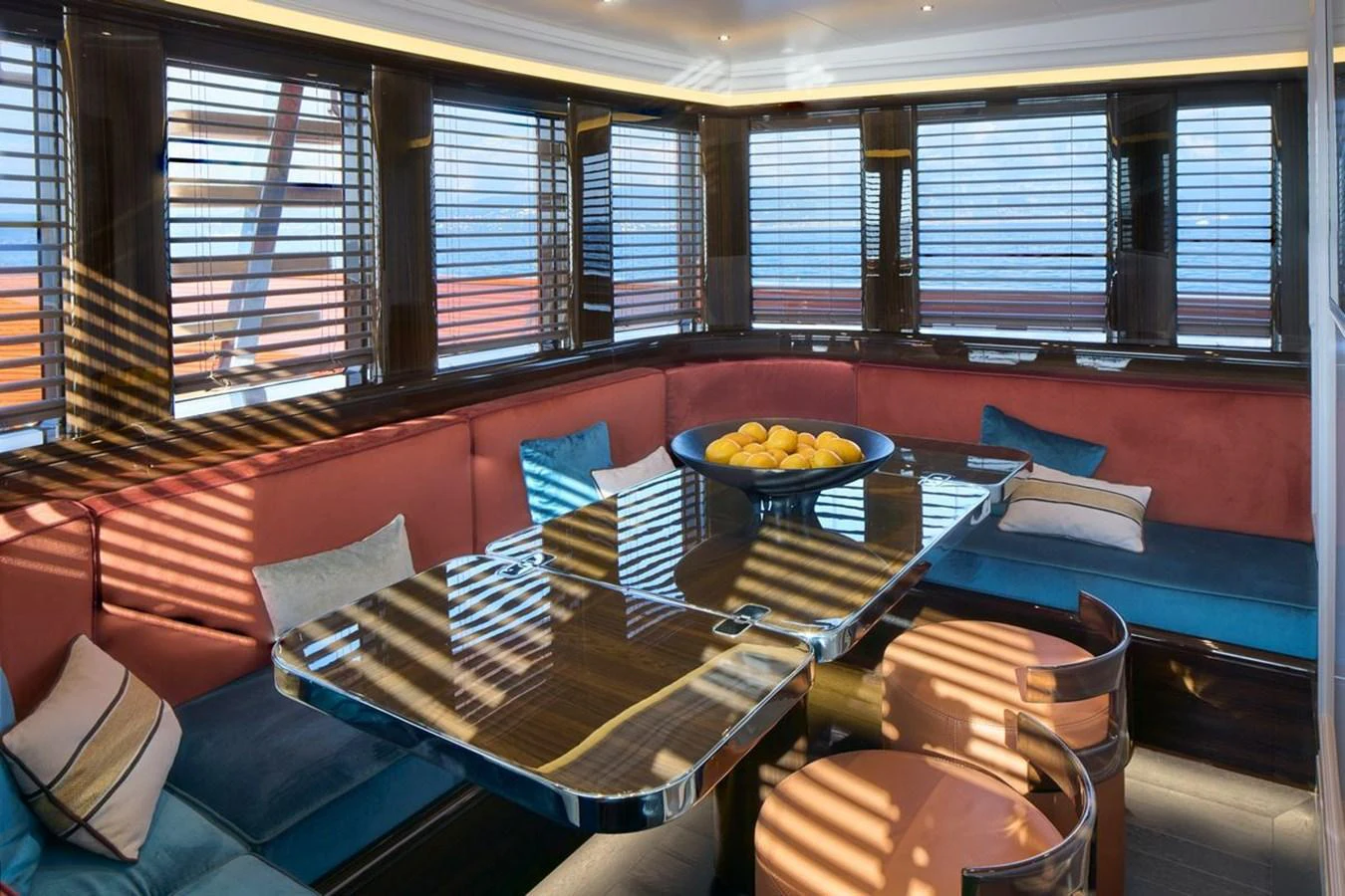 The yacht's dining area features a sleek table surrounded by comfortable seating, with large windows providing ample natural light. aboard PICCHIOTTI 24 Yacht for Sale
