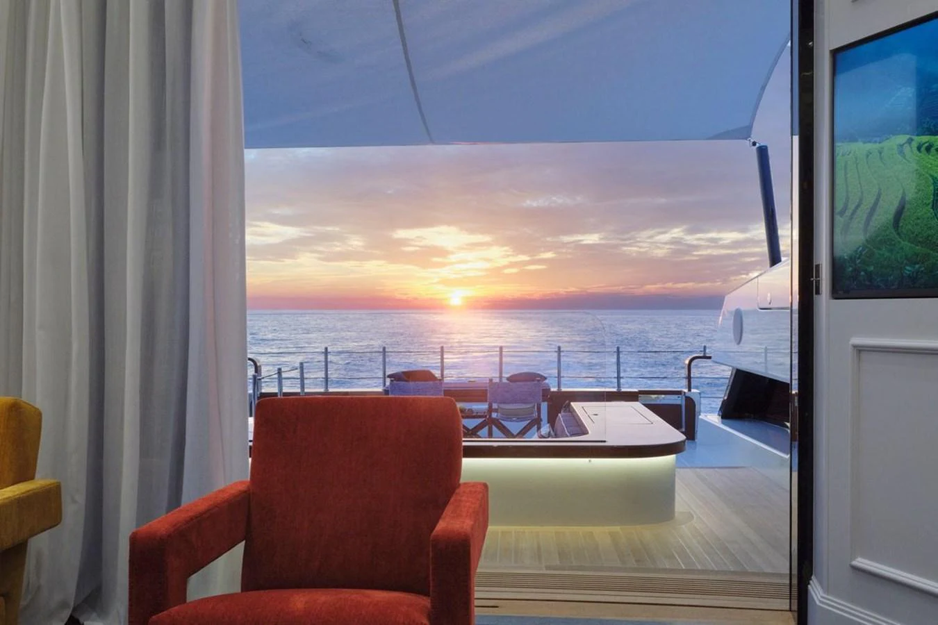 A luxurious interior space opens up to a stunning ocean sunset view. aboard PICCHIOTTI 24 Yacht for Sale